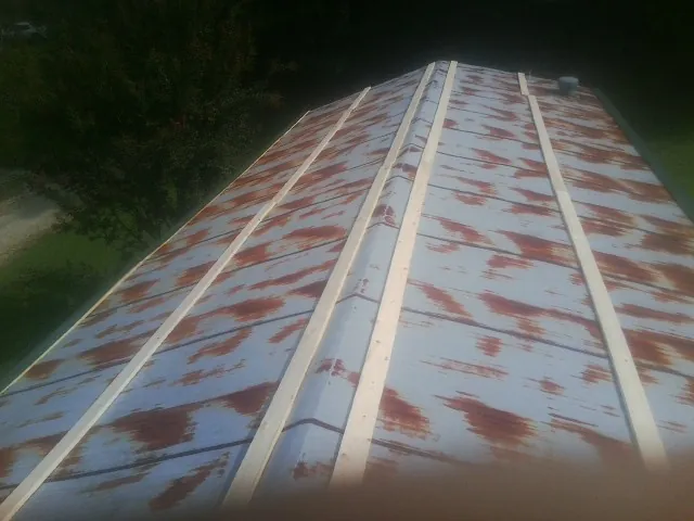 Rusted metal roof panels with new wood purlins before replacement — Storm Damage Roof Repair in Apalachin by Roofing Brothers