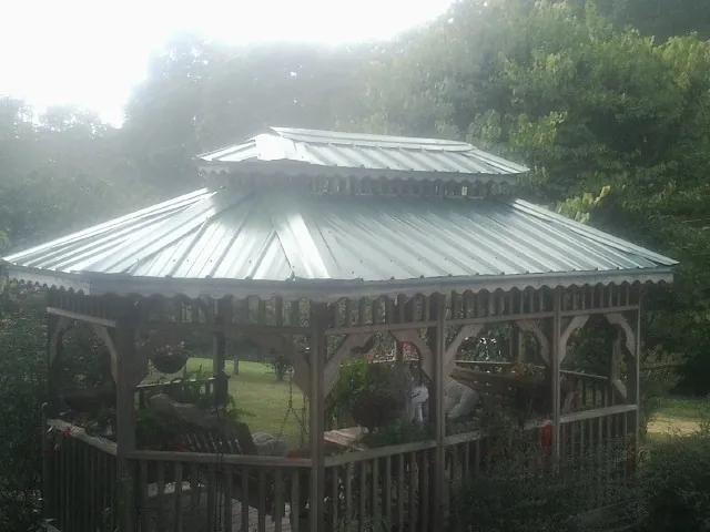 Two tier green metal roof on a garden gazebo in Apalachin