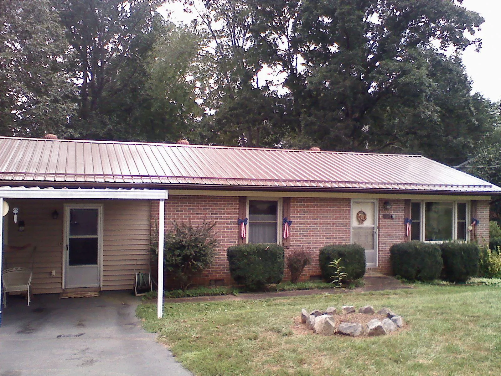 Bronze metal roof and carport on a brick ranch home — Roof Repair work by our crew in Apalachin